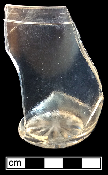 Tumbler (Packers’ Tumbler) of colorless soda lime glass. 2” base diameter; 3.5” height. Jones Commercial container  re-used as a tumbler. 2000:219). 18CV13